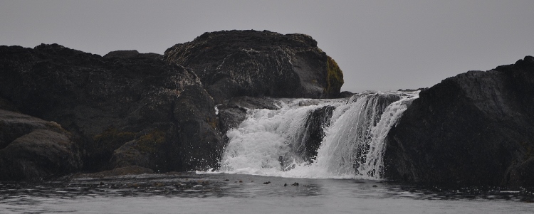 waterfall over beach rock